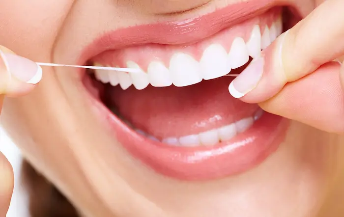 استفاده مرتب و روزانه از نخ دندان بعد از جرم گیری 165241651261456